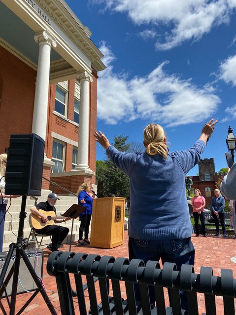 A DAY OF PRAYER: Barbara Bartlett sways to the music accompaniment of worship leader Linda Cantone and guitarist Steve Mattall as they perform a rendition of America the Beautiful during the observance of the National Day of Prayer Thursday at City Hall.