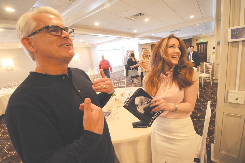 WRITER, AGENT, PUBLISHER:&nbsp; Author Raina Smith and Steve Tilley, a member of the Warwick Rotary Club, exchange stories following her presentation about her books Thursday.