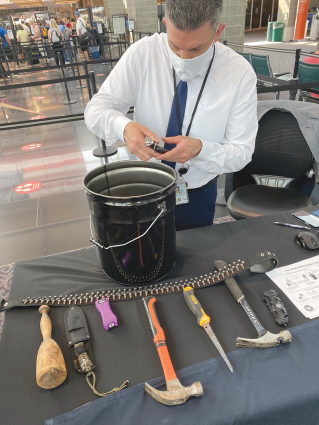 NO FLY ZONE:&nbsp; Dan Velez, spokesperson for New England TSA, showcases some of the items, like hammers, self-defense weapons, and saws, confiscated from travelers over the years.