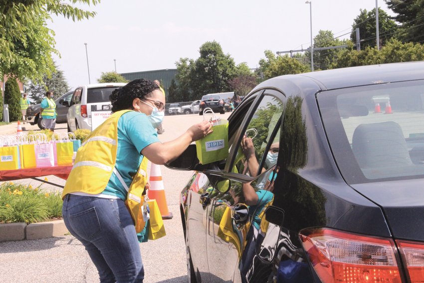 A LITTLE SOMETHING EXTRA: Those visiting the state&rsquo;s first drive-thru vaccination clinic held Saturday in the RIPIN parking lot off Jefferson Boulevard were given a bag of goodies before their vaccination.