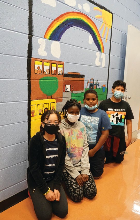 CREATIVE EFFORT: Edgewood Highland fifth-graders Briana Fondeur, Jessica Derisier, Gabriel De Oleo and Juan De La Rosa Bran pose with the mural they&rsquo;ve painted highlighting the joy to come post-pandemic.