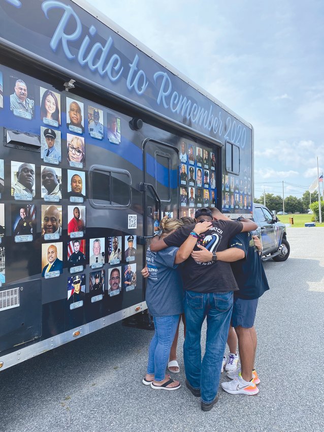 A MOMENT OF SILENCE: Lisa, Quinn, Stone and Ingrid Freeman gather with End of Watch founder Jagrut Shah in front of Lt. Russell Freeman&rsquo;s memorial. Freeman was one of 339 law enforcement officers nationwide who lost their lives in the line of duty last year.