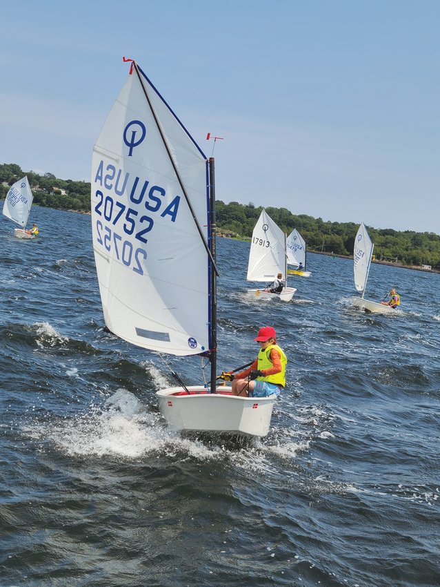 CLOSE QUARTERS: Strong winds and choppy waters required skilled sailing on the part of the young competitors. Here members of the Blue fleet prepare for the start of another race.