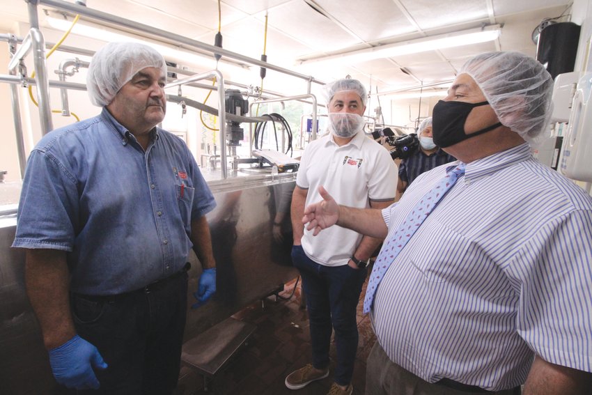 GENERATIONS OF EXPERIENCE: House Speaker K. Joseph Shekarchi, at right, talks with Thomas Bucci and his son Thomas Bucci Jr. whose family have operated Warwick Ice Cream since 1930. Both father and son talked about the problem they have in recruiting employees during the Speaker&rsquo;s visit to the Warwick-based operation.