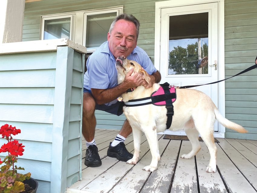 ANIMAL LOVER: Postal worker Charlie Donovan says one of the best parts about his  job is the furry friends, like Bailey the yellow lab.