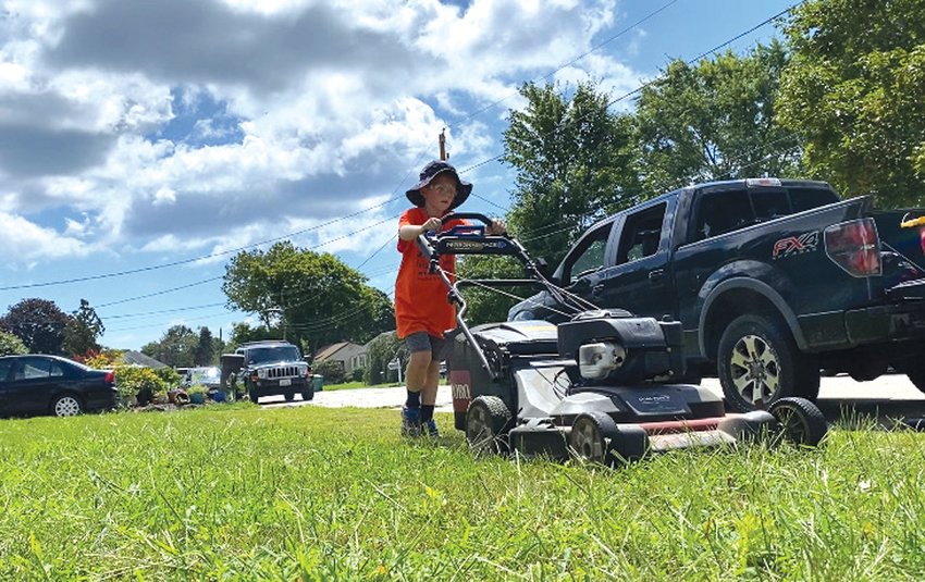 ONE LAWN AT A TIME:&nbsp; Liam Trudeau, 8, cuts another lawn in the 50 Yard Challenge.