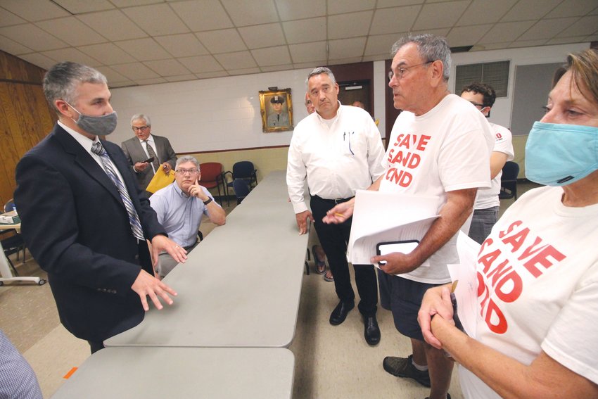 WHAT&rsquo;S THE NEXT STEP? City Solicitor David Petrarca, left, talks with Ward 3 Councilman Tim Howe, David Bouchard and members of Save Sand Pond following Monday&rsquo;s brief Zoning Board of Review Hearing. (Warwick Beacon photo)