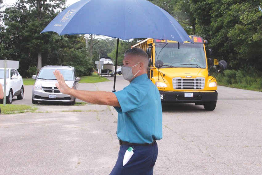 Like clockwork  Hoxsie Principal Gary McCoombs directed traffic ensuring a steady flow of buses and parents delivering  their children to school for the first day of classes yesterday.