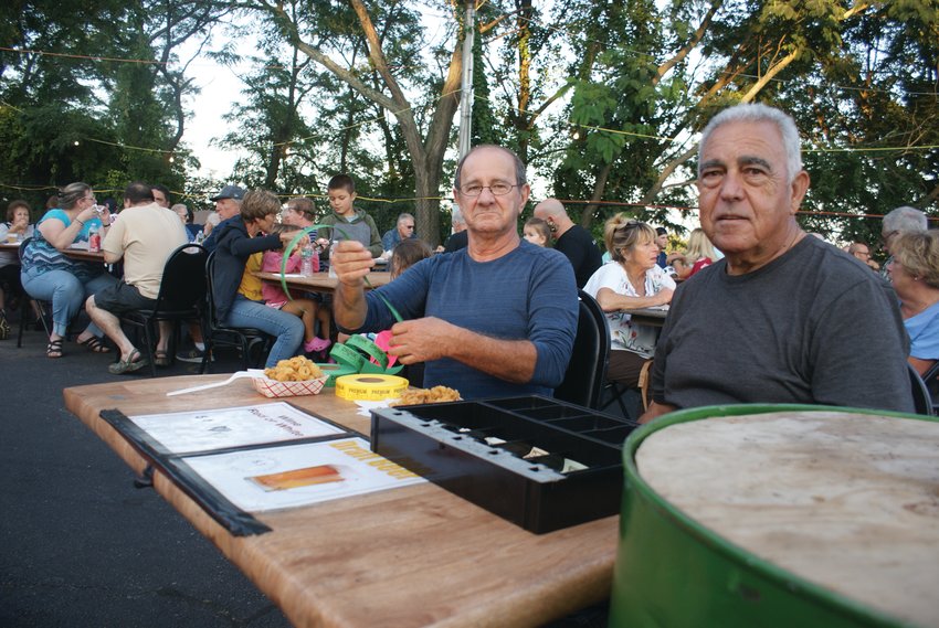 GET YOUR TICKETS HERE! Beer and wine tickets were available for purchase at the Feast of Santa Maria Di Prata. Pictured are Frank Rizzo and John Ciccone, both members of the Society.