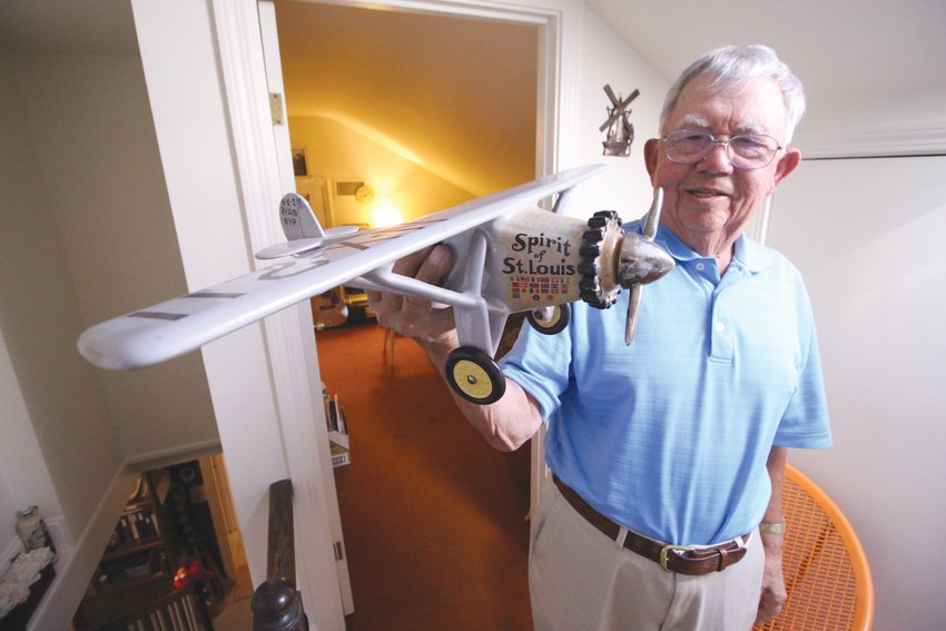 PAYING THE DOCTOR: Bill displays a porcelain model of the Spirit of St. Louis, which is actually a wine bottle, that  one of his patients gave him as a payment. Another patient, an elderly woman, gave him a gun rather than cash.