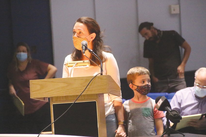 NEW TO WARWICK: Sarah Warren, who said the family recently moved to Warwick from Idaho, was anxious to learn when her son, Miles, who joined her at the podium, would be attending first grade in person.