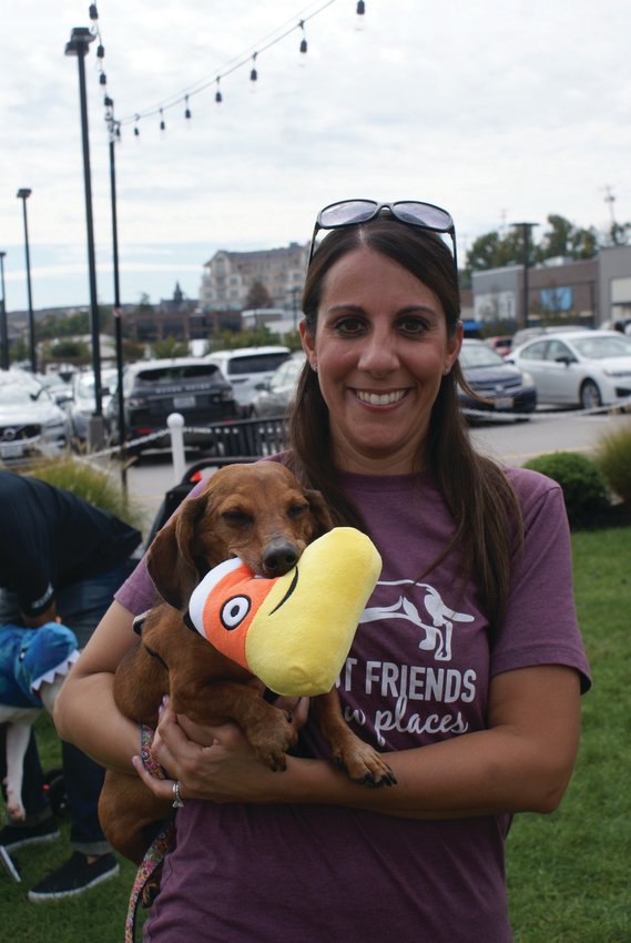 NEW MASCOT: Meet Garden City Center&rsquo;s new mascot, Louie, an 11-year-old Dachshund, pictured with his favorite chew toy and his mom, Regina Bifulco. His selection in the mascot contest was announced during the Yappy Hour.