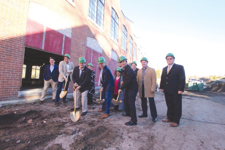 CEREMONIAL GROUNDBREAKING: Mayor Picozzi was joined by members of the City Council and AAA officials to commemorate work on the conversion of the saw tooth building in Apponaug into AAA offices and the City Hall Annex.