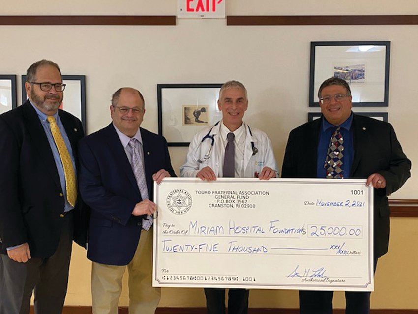 SUPPORTING CANCER RESEARCH: Dr. Howard Safran, second from right, chief of oncology at Miriam Hospital, accepts a $25,000 donation from Touro Fraternal Association for the hospital&rsquo;s Center for Innovative Cancer Research. Representing Touro are, from left, Jeffrey Davis, vice chairman of the board of directors; Barry Schiff, chairman of the Community Involvement Committee; and Stevan Labush, chairman of the board of directors. (Submitted photo)