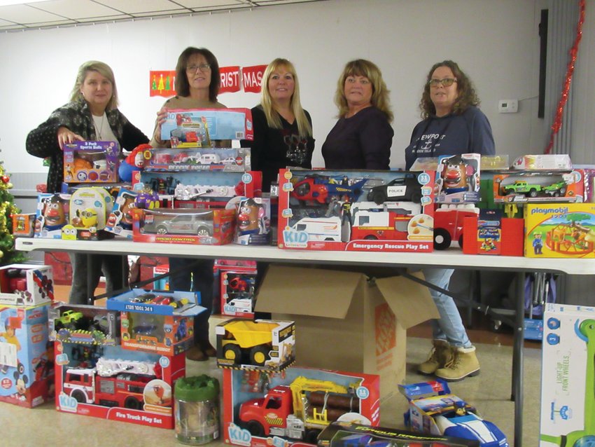 CLASSIC COLLECTION: Donna Breese, Carol DeLory, Dawn Kidd, Diane Denoncour and Ann-Marie Clancy are all smiles and standing behind a table topped with countless children&rsquo;s toys and games that were part of the Tri-City Elks highly-successful Holiday Cheer Program that will again benefit families in need, especially those with children, this Christmas.