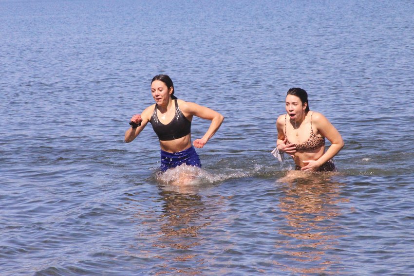 MAKE IT QUICK: Ali McGowan and Sarah Crowell make a dash for the beach after the  Mentor RI dip held in March.