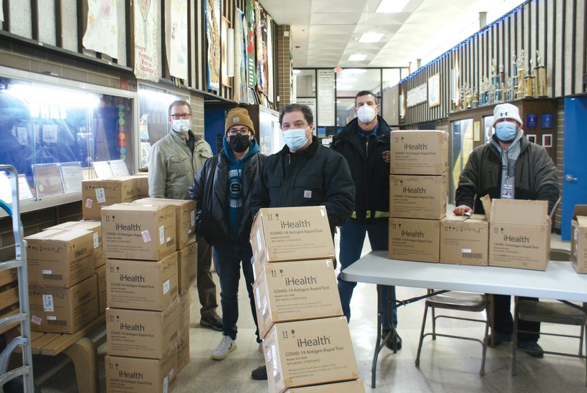 GETTING READY: Volunteers who arrived early helped to organize each kit given at the drive through locations at Western Hills Middle School. Pictured left to right is Tim Spikes (Custodian), Steve Paiva (Community Coordinator for Mayor Ken Hopkins), Councilman Ward 4 Richard Campopiano, Cranston Fire Chief James Warren and Foreman of Plant Operations Frank Sousa.