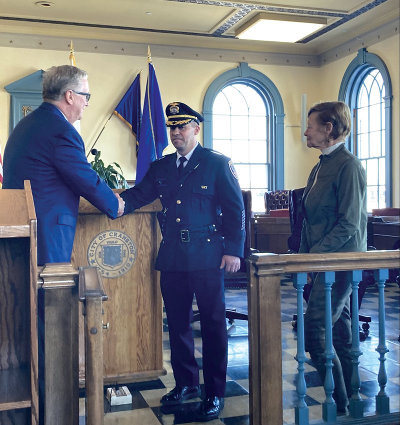 CONGRATULATIONS: Mayor Hopkins and Justin Dutra shake hands after the oath. Dutra&rsquo;s mother, Carol, waits to pin the new badge to her son&rsquo;s uniform as he assumes the rank of captain.&nbsp;