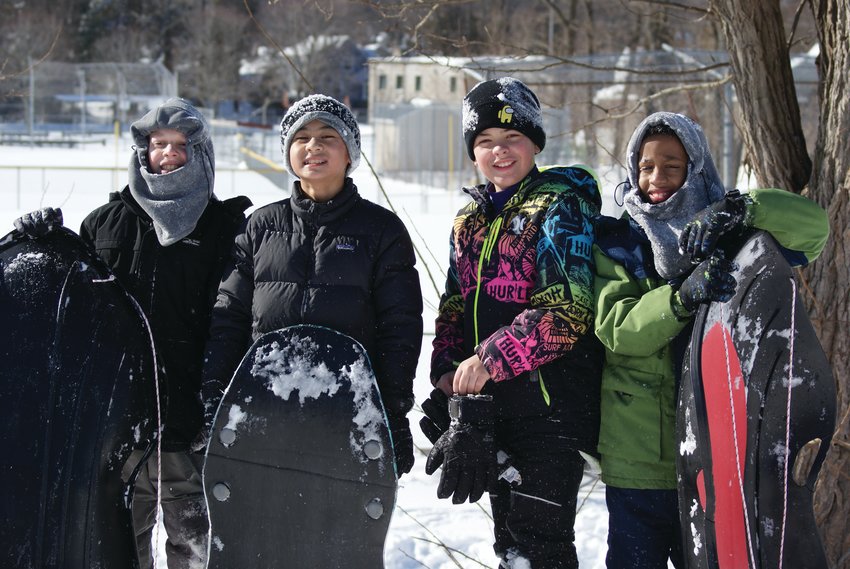 FRIENDS GATHER AT AQUADUCT FIELD: On Sunday afternoon four 11-year-old friends gathered to sled. Ivan Her, Xavier Balcarcel and brothers Cody and Sean Gonyea enjoyed their time together. The Budlong pool is in the background.