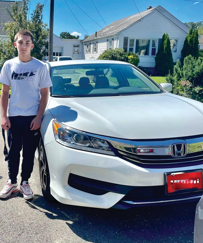 WITH HONDA: Sean poses with the 2020 Honda Accord he  purchased by working part-time as a culinary aide at the St.  Elizabeth Home in East Greenwich. (Courtesy of Gina Clapprood)