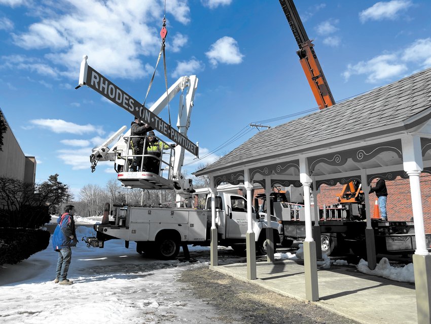 READY FOR TAKE OFF: AA Thrifty Sign and Awning use a crane to lift the 21 foot long sign that weighs over a hundred pounds.