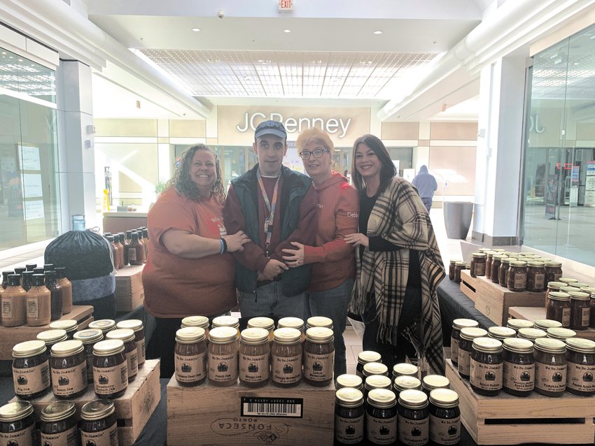 WE BE JAMMIN: Above, Jessica Botelho (far right) interviewed Debbie Wood for a story about her business We Be Jammin, which is located on West Shore Road. On Feb. 19 Botelho, Wood and her son Jason sold the products at the information booth at the Warwick Mall and all the proceeds went to Botelho&rsquo;s fundraising efforts.