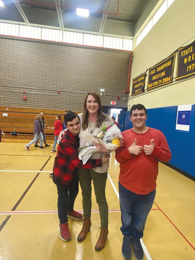 RECEIVING NOMINATION: Cannon receives a hug from eighth grader Maxx Manzi. Maxx and his brother Jake have worked closely with Cannon since they were in sixth grade. The boys&rsquo; mom nominated Cannon for this award.