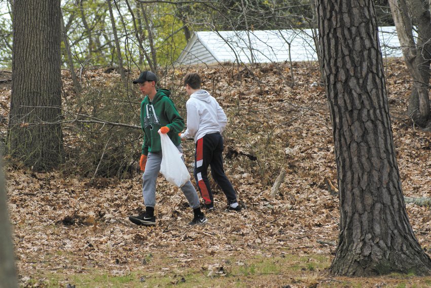 FRIENDS: Pictured are Aidan Paplauskas and his friend, Jesse Mantia-Hall, working hard at the Meschanticut Park cleanup this past Sunday.