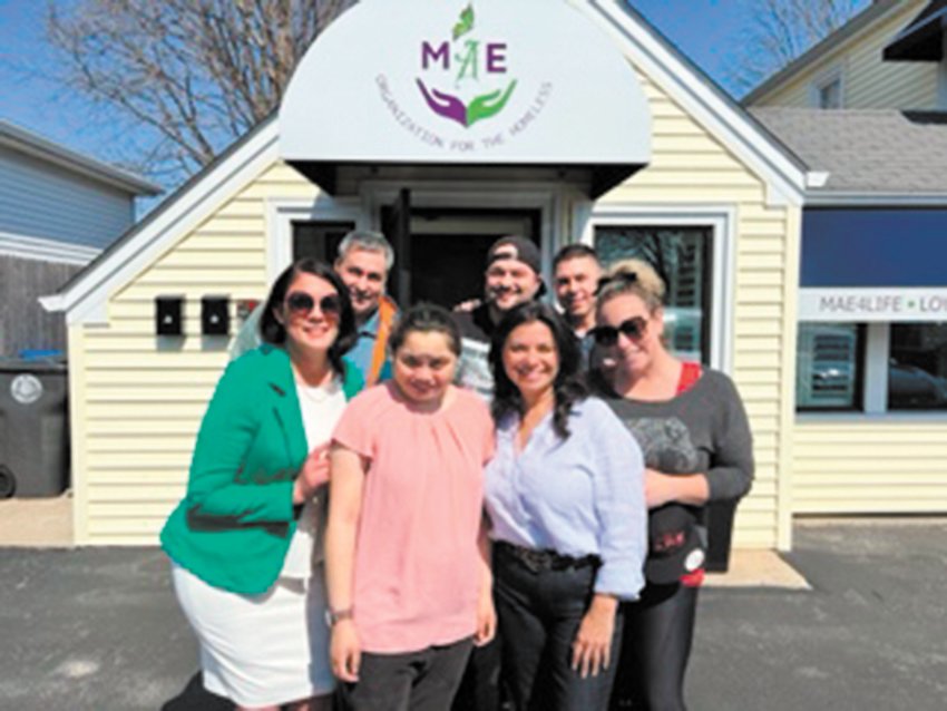 IT TAKES A VILLAGE: Emily Sanita, is surrounded by members of her support team outside the MAE Organization in Cranston. (Photo courtesy of Emily Sanita)