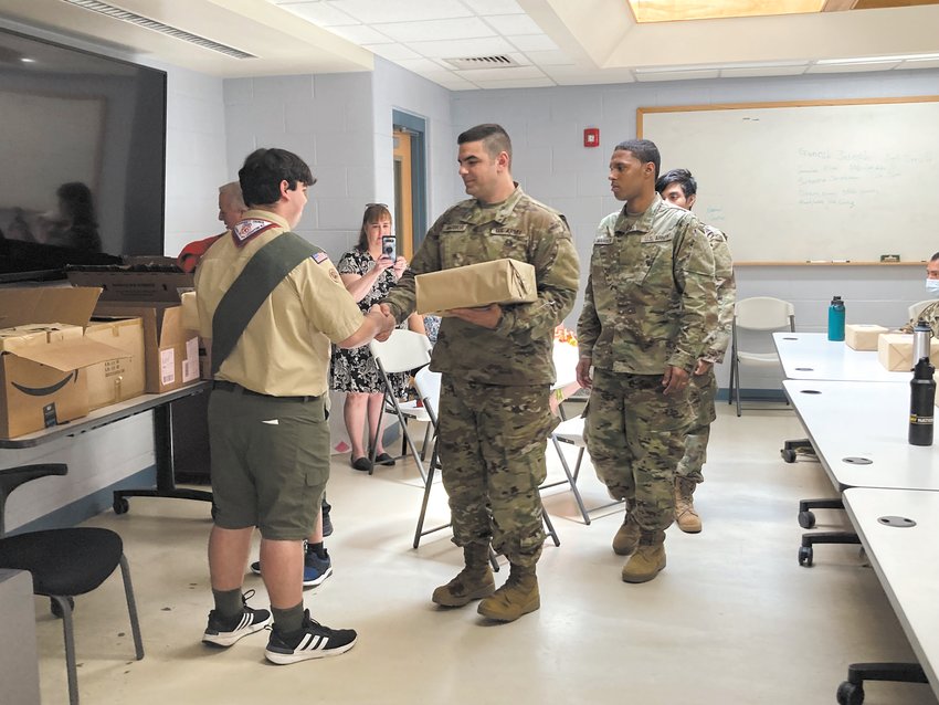 PASSING OUT CARE PACKAGES: Stephen Caniglia passed out packages to members of the National Guard RSP. Stephen held a collection drive where individuals could donate snacks, toiletries and paper products for those who would be going to basic training.