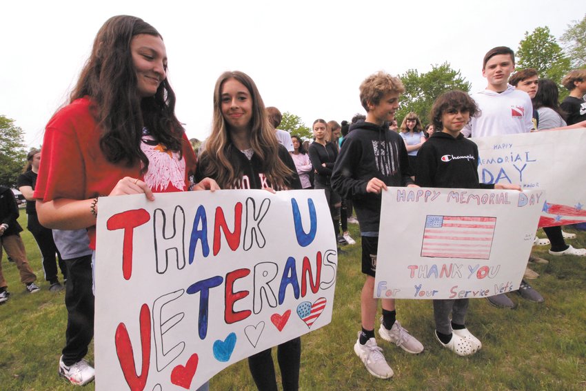 SIGNS OF APPRECIATION: Vets Middle School 8th graders Gabby Mota and Taylor Mooney were among students making signs to welcome veterans attending Tuesday&rsquo;s remembrance.