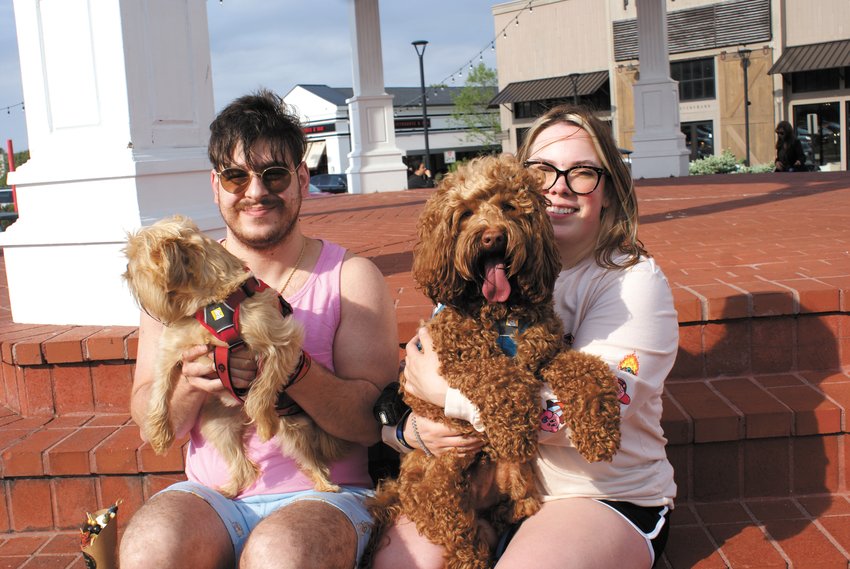 FRIENDS: Chris DeFazio, holding Charlotte (a Brussels griffon,) and Shay DeFazion, holding Merlin (a mini Australian Labradoodle, during Yappy Hour in Garden City Center.