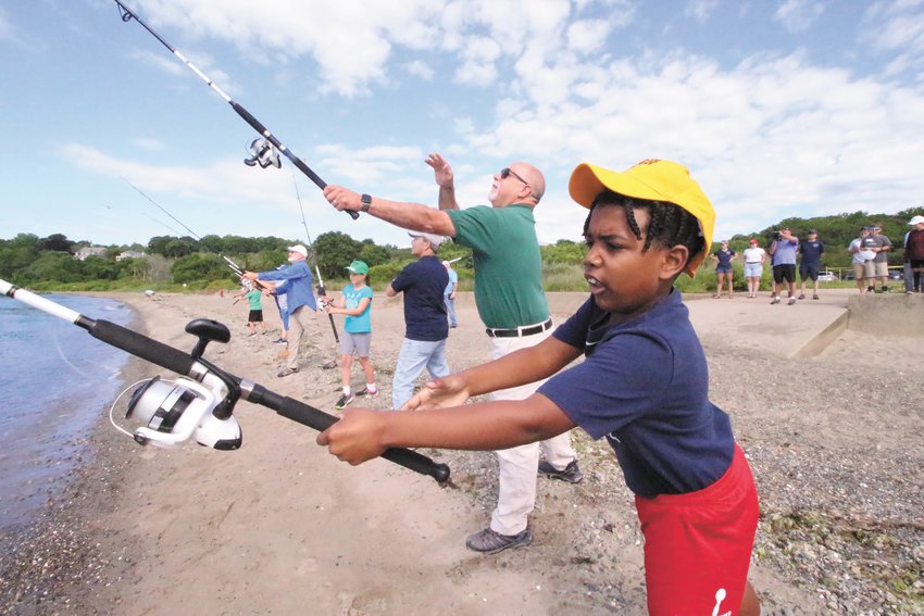 PHOTO OP: A member from each of the camp teams plus officials and select association members formed a semicircle as they made a cast to signal the start of this year&rsquo;s fishing camp.