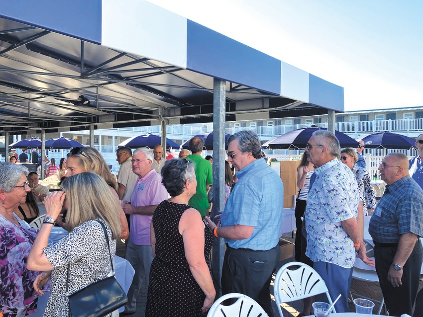 50 YEARS LATER: Classmates catch up with each other at the reunion held at Bonnet Shores Beach Club. (Herald photo)