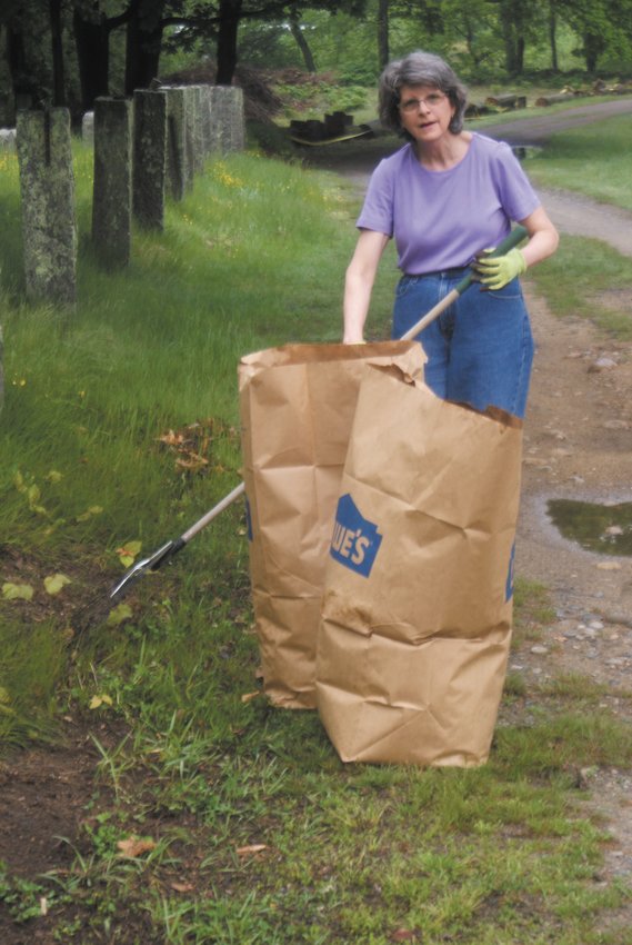 VOLUNTEERING: Molly Tognettu bagged leaves during the clean up of the Pocasset cemetery.