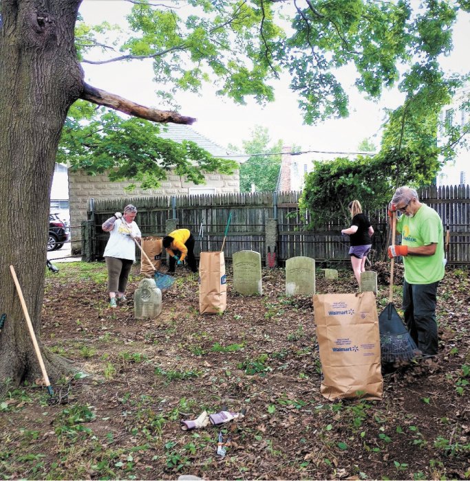 TIME TO CLEAN UP: From (left) Jennifer Wendt, Nicole Johnson-Morais, Makenna Hanson and John Hill were among the group of individuals helping clean the cemetery earlier this month; Johnson-Morais and Hill are members of the Cranston Historical Cemeteries Commission. (Submitted photo)