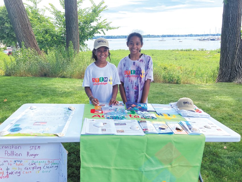 KEEP THE COVE CLEAN: (From left) Jealy Balbuena, who attends Gladstone Elementary School, and Jaelyn Morales, who attends Park View Middle School, sold key chains and bookmarks on Friday to raise funds for Stillhouse Cove to keep the area clean. (Herald photo)