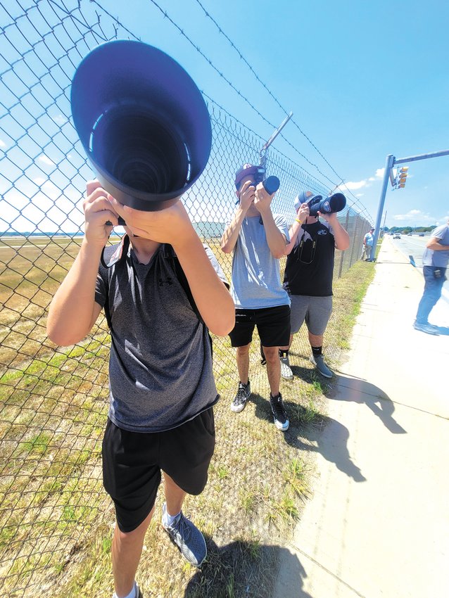 AIR ENTHUSIASTS: From left to right, aviation enthusiasts Jake Fernandes, 13, of New Bedford, 13, Sterling Beaucage, of Warwick, and Nate Hall, of Providence, gathered outside Rhode Island T.F. Green International Airport awaiting the arrival of US President Joe Biden. (Beacon photos by Rory Schuler)