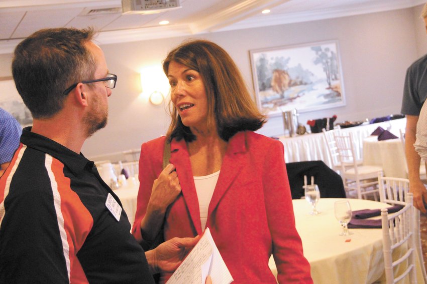 VISITING ROTARY CLUB: Democratic candidate for governor, Helena Foulkes, visited the Warwick Rotary Club Thursday. Here she talks with club member Chris Sanford. (Herald Photo)