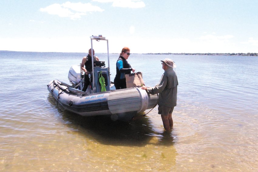 READY TO ANSWER QUESTIONS: RIMAP volunteers manned the on-shore research station answering questions from beachgoers and people following the hunt for the Gaspee as well as conducting searches in the shallows of Gaspee Point.