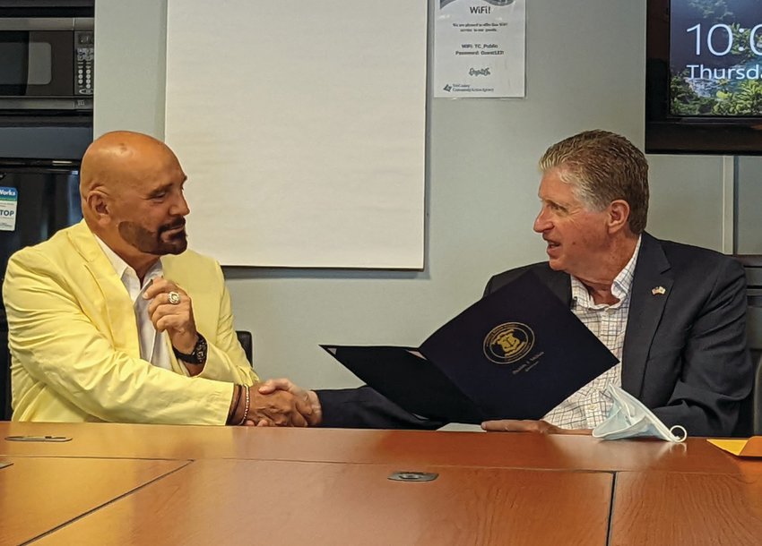 TERRIFIC TRIBUTE: Gov. Dan McKee is all smiles prior to presenting Tri-County Community Action Agency President/CEO Joseph R. DeSantis with a certificate of special recognition for providing Rhode Islanders with basic health care needs as well excellent medical and dental care.