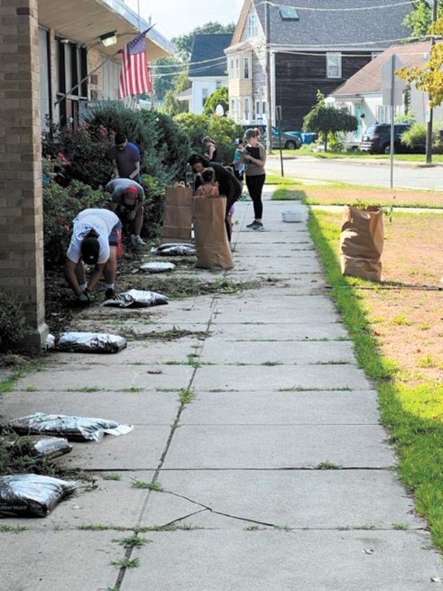 CURB APPEAL IS EVERYTHING: Community volunteers working on improving the Stadium Elementary front entrance.