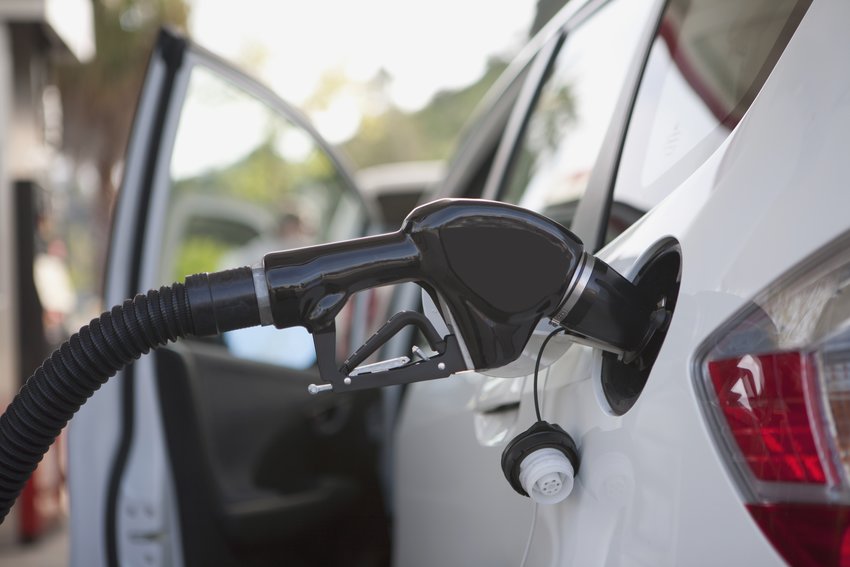 gasoline pump in car nozzle at gas station