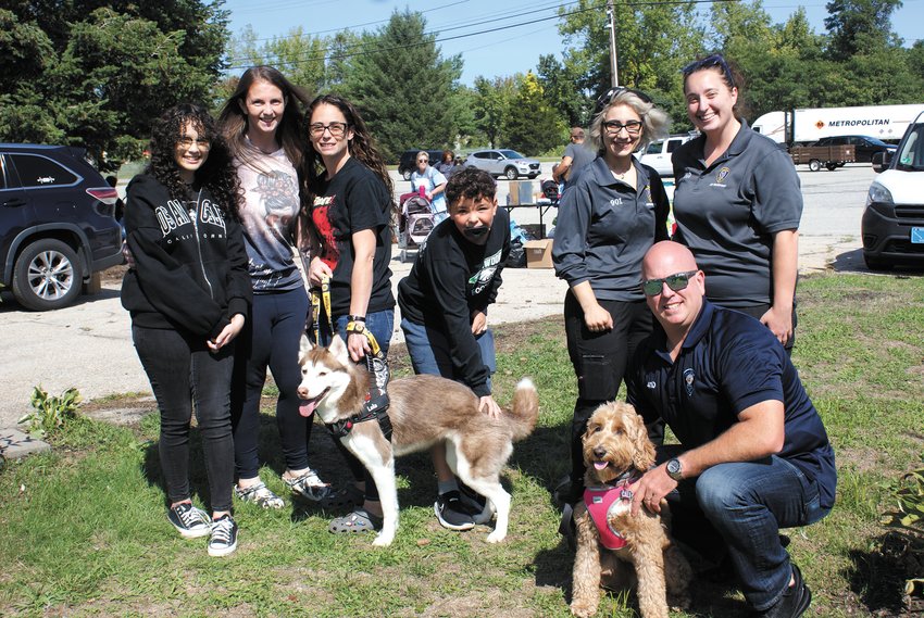 FAMILY OUTING: (From left) Savana, 13, Jessica, Ashley and Izaiah, 10, visited the Cranston Animal Shelter on Saturday with their husky, Lola. Pictured with the family are Nicole Cioffi, the adoption coordinator for Cranston Animal Shelter, Shelby Boudreaux, the Animal Control Supervisor and Cali &ndash; the Cranston Police Department&rsquo;s therapy dog &ndash; and Detective Mike Iacone.