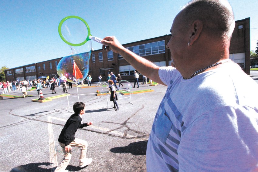 BURSTING HIS BUBBLES: Sonny Barnes made some huge bubbles which his grandson, Xavier, had a blast popping.