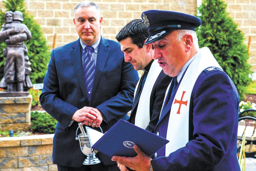 Father in uniform at an event at the Bishop Hendriken Prayer Garden.