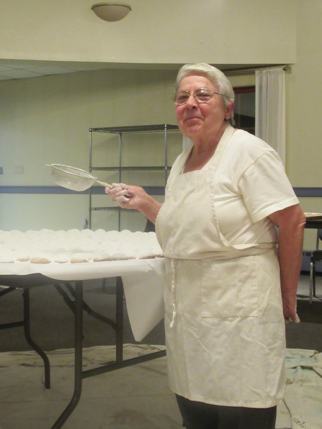 DELICATE DUTY: Pauline Haralambides puts the finishing touches on a tray of Greek Malomakarona cookies that will be on sale this weekend in Cranston.