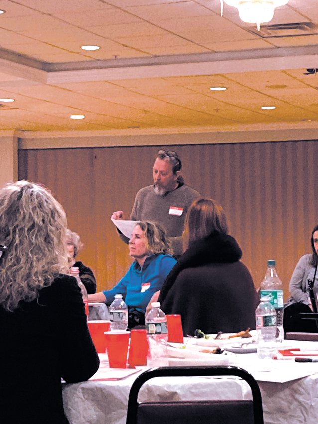 SHARING WITH THE GROUP: Tim Mcfate shares what his group talked about during their 45-minute conversation.   (Herald photo)