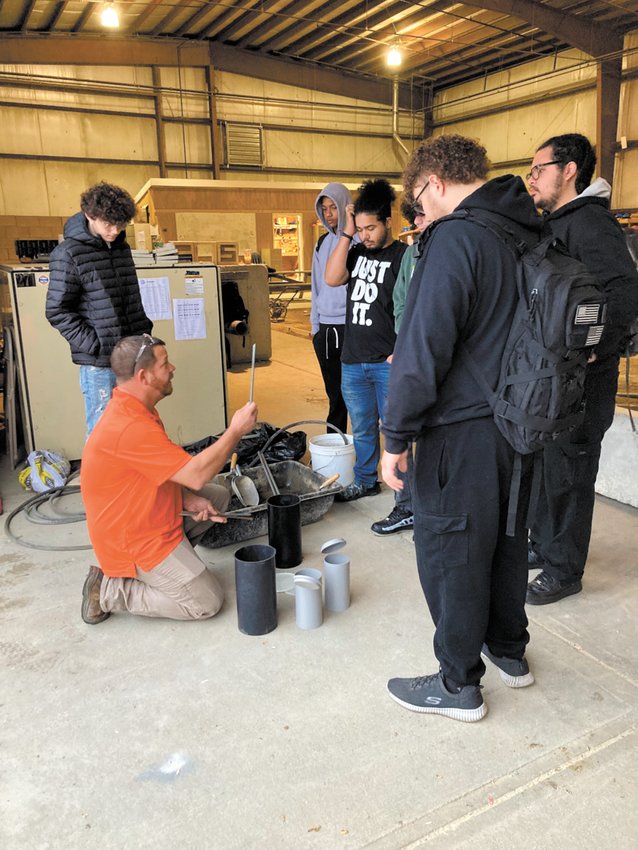 WATCH AND LEARN: Scott Zinke, who&rsquo;s been working with seniors to prepare them for their upcoming ACI (American Concrete Institute) Concrete Field Testing Technician &ndash; Grade I certification test, demonstrates some on the hands-on testing that students may experience on Nov. 15. (Herald photo)