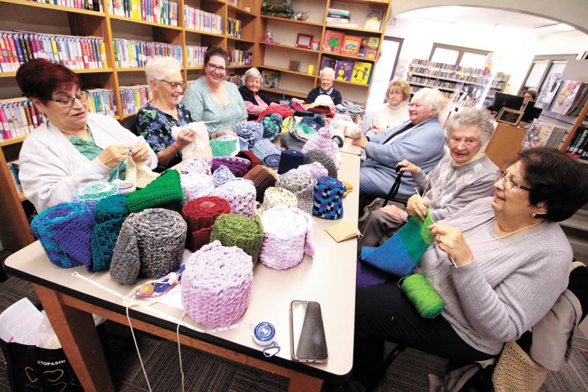 NETWORK OF KNITTERS: The Conimicut Knitters that meet Wednesdays at the Conimicut Library did their part to provide hats and scarves for the coat drive run by the Tri-City Elks Lodge #4 and the Warwick Public Library. The knitters provided enough scarves to fill the tables they gather around and then some to share stories and chat while performing this community service. Their contributions were augmented by the work of the Red Sox Knitters Group,&nbsp;Warwick Public Library Knit &amp; Crochet,&nbsp;The Apponaug Knitters Group and Nancy DiPonte. Doing their thing clockwise around the table are Mary Kennedy, Janet Quigley, Carolyn Bunszell, Carol Fredette, Gladys Miller, Marge Ovalles, Jane Goldberg, Betty Law and Beverly DeLuca.  (Warwick Beacon photo)